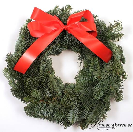 Julkrans av färskt ädelris med röd rosett