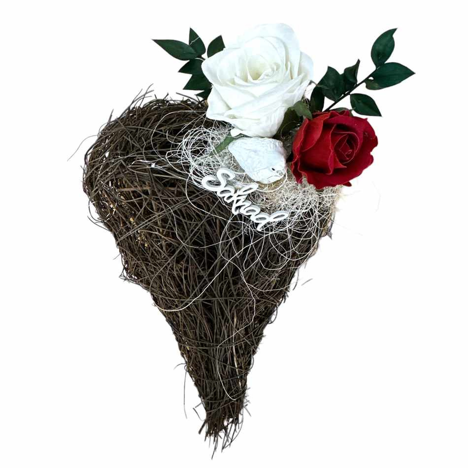 Gravdekoration med två rosor i vitt och rött, duva och skylt